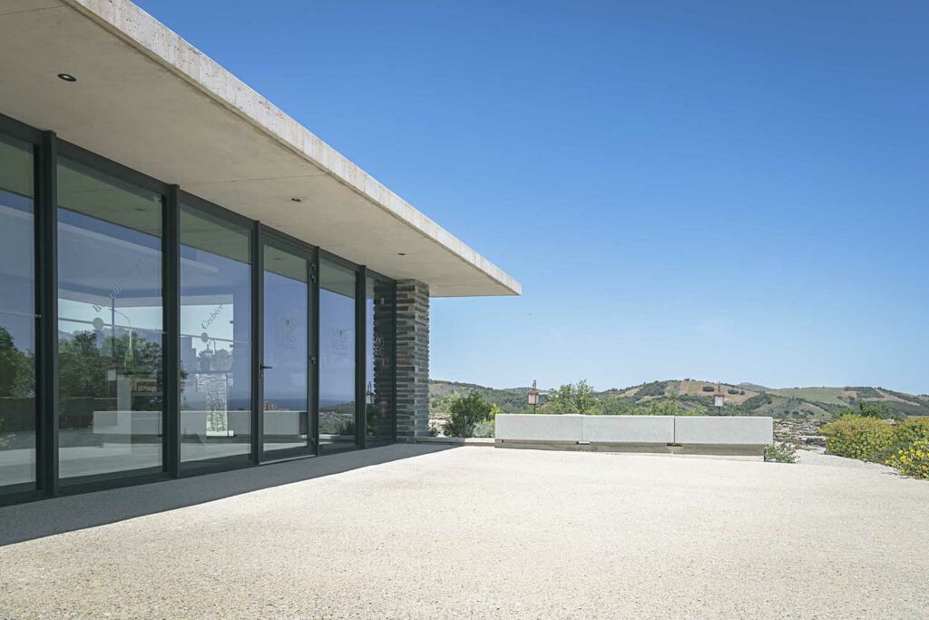 Baies vitrées aluminium noir, terrasse moderne, vue paysage Méditerranée, menuiserie laquée